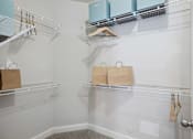 Thumbnail 10 of 56 - A kitchen pantry with a white wall and a door.