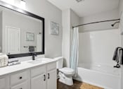 Thumbnail 17 of 56 - A white bathroom with a sink, toilet, and bathtub.