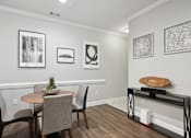 Thumbnail 5 of 56 - A dining room with a table and chairs.