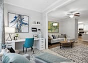 Thumbnail 8 of 56 - A modern living room with a blue chair and a white desk.