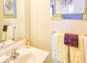 Thumbnail 24 of 36 - A white sink with a purple towel hanging on the towel rack.