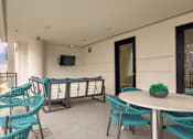 Thumbnail 22 of 40 - A balcony with a table and chairs overlooking a mountain.