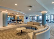 Thumbnail 19 of 40 - A modern living room with a large circular table and comfortable seating.