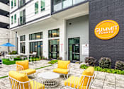 Thumbnail 6 of 40 - A yellow chair is in front of a Summit Pointe sign.