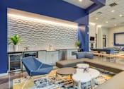 Thumbnail 18 of 40 - A modern living room with a blue accent wall and a variety of seating options.