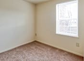 Thumbnail 19 of 36 - A room with a window and carpeted floor.