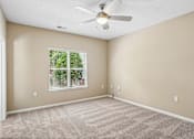 Thumbnail 62 of 67 - A room with a ceiling fan and a window with blinds.