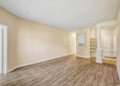 Thumbnail 60 of 67 - A room with wooden flooring and white walls.