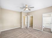 Thumbnail 54 of 67 - A room with a ceiling fan and carpeted floor.