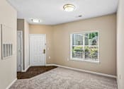Thumbnail 53 of 67 - A room with a white door and a window with blinds.