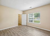 Thumbnail 49 of 67 - A room with a white door and a window with blinds.