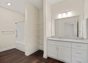 Thumbnail 11 of 27 - a bathroom with a large mirror and a toilet and a shower