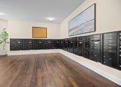 Thumbnail 25 of 27 - a lockers room with wood floors and a painting on the wall