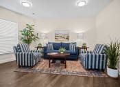 Thumbnail 18 of 27 - a living room with blue and white furniture and a rug