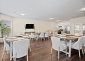 Thumbnail 22 of 27 - a dining room with tables and chairs and a kitchen