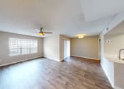 Thumbnail 31 of 40 - an empty living room with a ceiling fan