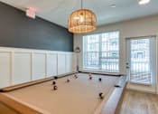 Thumbnail 33 of 40 - A pool table with balls set up in a rack.