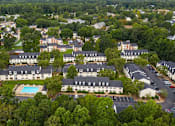 Thumbnail 7 of 13 - A bird's eye view of a residential area with houses and a swimming pool.
