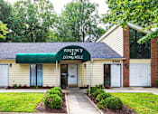 Thumbnail 2 of 13 - A building with a green awning and a sign that says