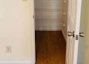 Thumbnail 9 of 13 - A white door with a silver handle is open to a hallway with a number 1 on the wall.