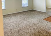 Thumbnail 8 of 13 - A room with a carpeted floor and two windows.