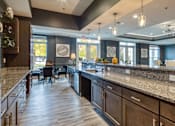 Thumbnail 5 of 24 - a large kitchen with granite counter tops and a dining area