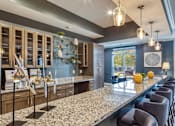 Thumbnail 4 of 24 - a kitchen with granite counter tops and a long island