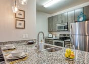 Thumbnail 13 of 24 - a kitchen with stainless steel appliances and granite counter tops