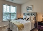 Thumbnail 23 of 24 - a bedroom with a large bed and a window