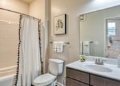 Thumbnail 22 of 24 - a bathroom with a shower toilet and sink and a mirror