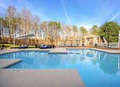 Thumbnail 14 of 20 - A large swimming pool with a deck and sun loungers.