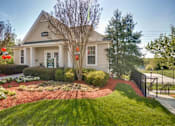 Thumbnail 5 of 36 - A house with a green sign on the front door.