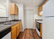 Thumbnail 13 of 36 - A kitchen with wooden cabinets and a white refrigerator.