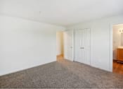 Thumbnail 24 of 36 - A room with white walls and a grey carpet.