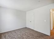 Thumbnail 26 of 36 - A room with a carpeted floor and a white door.