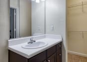 Thumbnail 54 of 62 - A bathroom with a sink and mirror.