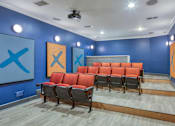 Thumbnail 53 of 62 - A room with blue walls and orange chairs.