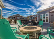 Thumbnail 12 of 53 - a patio with chairs and a fire pitat Blue Ridge Commons Apartments, Virginia