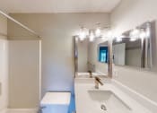 Thumbnail 26 of 40 - a bathroom with a sink mirror and toilet