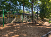 Thumbnail 37 of 39 - a playground with a slide and monkey bars in front of a house