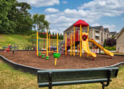 Thumbnail 15 of 21 - a childrens play area with a playground and a bench