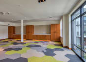 Thumbnail 70 of 81 - a large room with a colorful carpet and large windows at Ainsworth, Richmond, Virginia