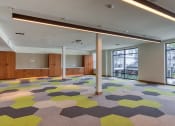 Thumbnail 69 of 81 - a large room with a colorful carpet and windows at Ainsworth, Richmond