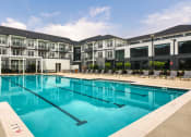 Thumbnail 9 of 81 - a swimming pool with apartment buildings in the background at Ainsworth, Richmond