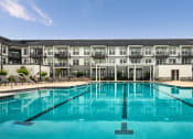 Thumbnail 50 of 81 - a swimming pool with an apartment building in the background at Ainsworth, Virginia