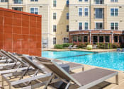 Thumbnail 7 of 60 - a swimming pool with lounge chairs on the sun deck at Proximity at ODU, Norfolk