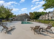 Thumbnail 33 of 43 - our apartments have a large pool and patio with chairs at Village 1373, Greensboro North Carolina