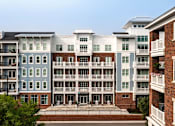 Thumbnail 41 of 42 - A row of apartment buildings with balconies and doors.
