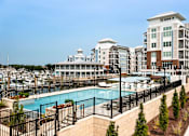 Thumbnail 16 of 42 - A large building with a pool in front of it.