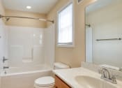 Thumbnail 7 of 21 - a bathroom with a shower toilet and sink and a mirror